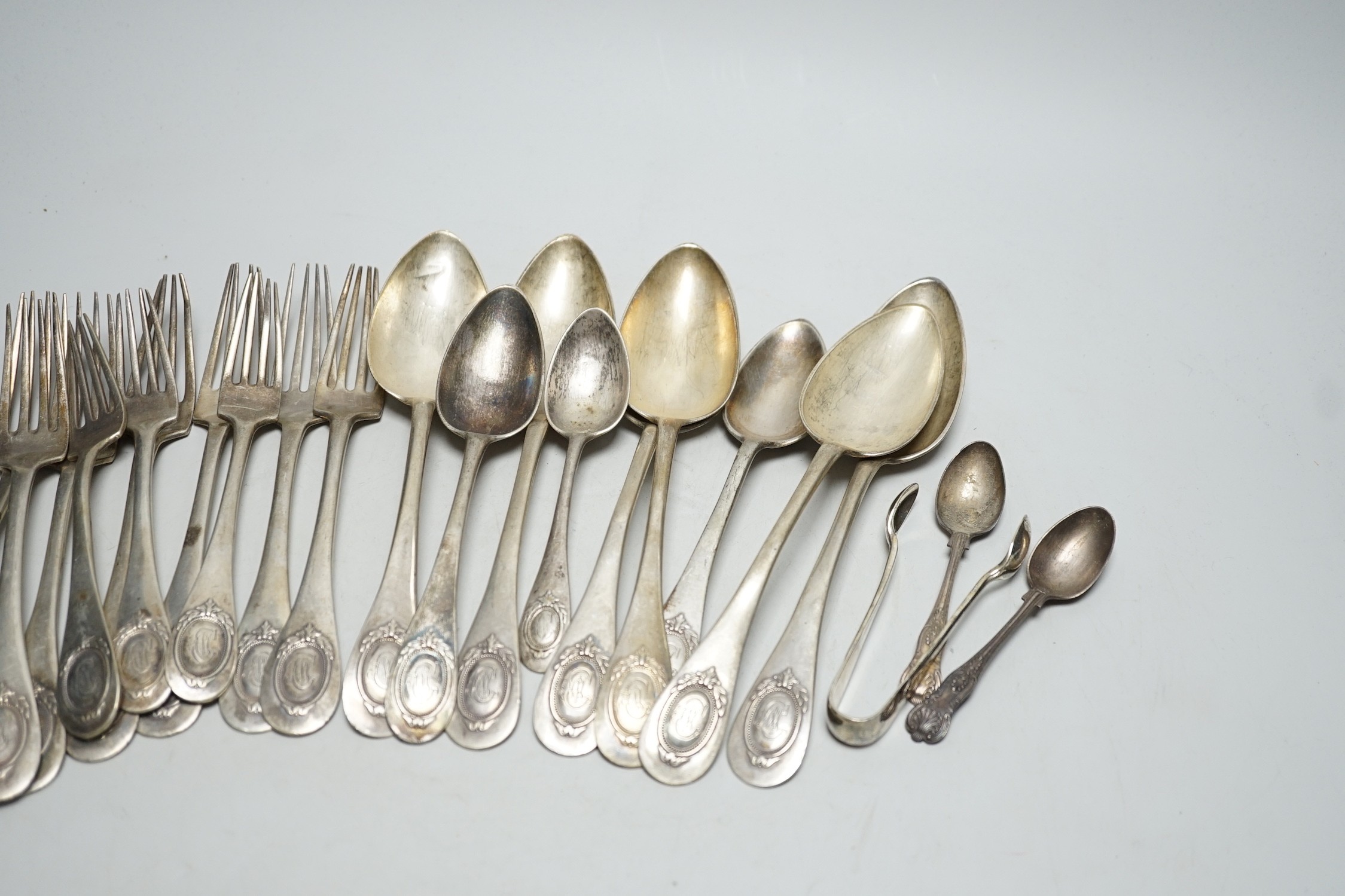 Twenty assorted items of German 800 standard white metal cutlery and three English silver items of cutlery, 39.1oz.